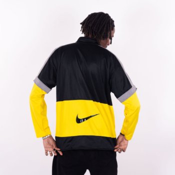 Veste vintage Nike noire et jaune avec patch Mission 2000 et swoosh texturé au dos.